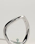 Elegant wave design wedding band by Kynora CJ, showcasing a sleek, modern wedding ring with a smooth, flowing pattern.