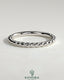 Elegant woven band wedding ring by Kynora CJ with intricate braided design in polished metal, perfect for bridal jewelry.