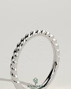 Kynora CJ woven band wedding ring with intricate woven design in silver-tone metal, elegant and suitable for special occasions.