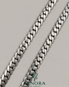 10mm plain Cuban link chain necklace in 10K white gold, hiphop style by Kynora Jewels, showcasing a sleek, polished jewelry piece