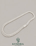 Sterling silver 10mm VVS moissanite Cuban link chain from Kynora Jewels, showcasing a shiny, bold hip-hop jewelry style.