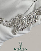 Sterling silver Cuban link chain with 10mm VVS Moissanite diamonds and customized name pendant, hip-hop jewelry by Kynora Jewels.