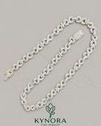 Kynora Jewels 10mm VVS Moissanite diamond infinity and cross pendant on 925 silver Cuban chain, hip-hop jewelry style.