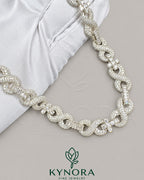 Kynora Jewels 10mm VVS Moissanite diamond infinity and cross pendant on silver Cuban chain, hip hop jewelry style.