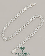 Sterling silver hip-hop chain featuring 10mm VVS moissanite diamonds with infinity and cross pendants, by Kynora Jewels.