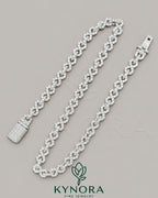 Sterling silver 10mm VVS1 moissanite diamond infinity hip-hop chain by Kynora Jewels, unisex jewelry with custom design.