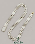 14mm VVS Moissanite diamond silver Cuban link chain by Kynora Jewels, featuring white gold accents and 18-inch sterling silver design.