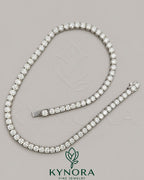 Sterling silver 18-inch tennis chain with 5.5mm VVS1 moissanite diamonds from Kynora Jewels, showcasing the detailed hiphop chain design.