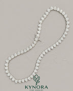 Heart-shaped moissanite diamond halo pendant on sterling silver tennis link chain, featuring a 7mm VVS1 moissanite from Kynora Jewels.