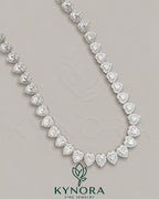 Heart-shaped moissanite diamond halo pendant on a 7mm sterling silver tennis link chain, stylish hip-hop jewelry by Kynora Jewels.