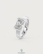 Moissanite radiant cut solitaire engagement ring with wide sterling silver band by Kynora Jewels, showcasing the sparkling gemstone.