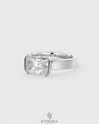 Moissanite radiant cut solitaire engagement ring with wide band in sterling silver by Kynora Jewels.