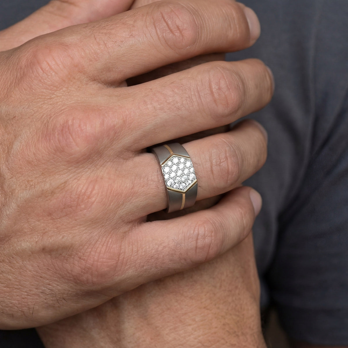 Men's titanium ring with hexagon cluster moissanite stones set in 10k yellow gold, showcasing a modern jewelry design.