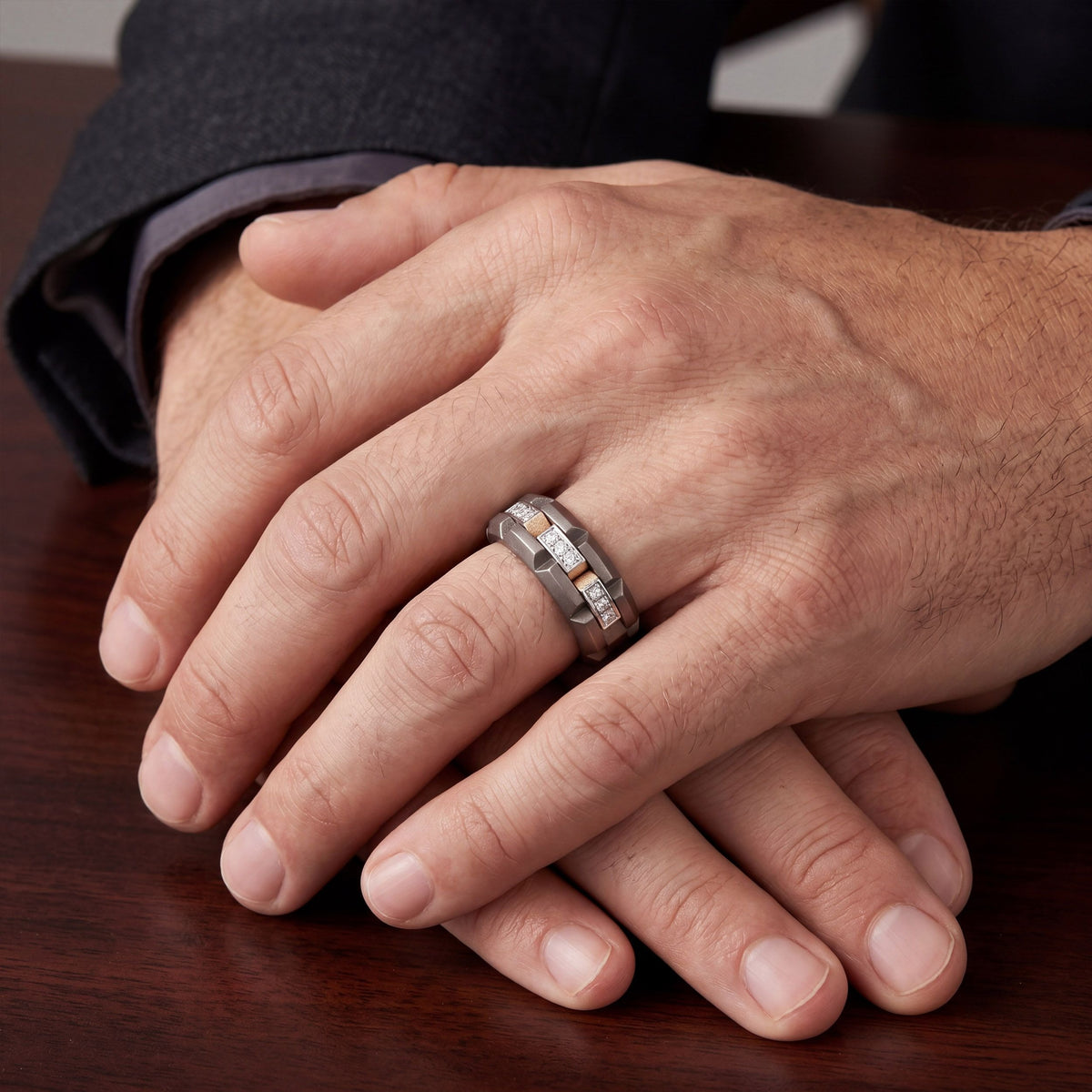 Men's Moissanite station band ring in 10k yellow gold and titanium, featuring a sleek, modern design with sparkling stones.