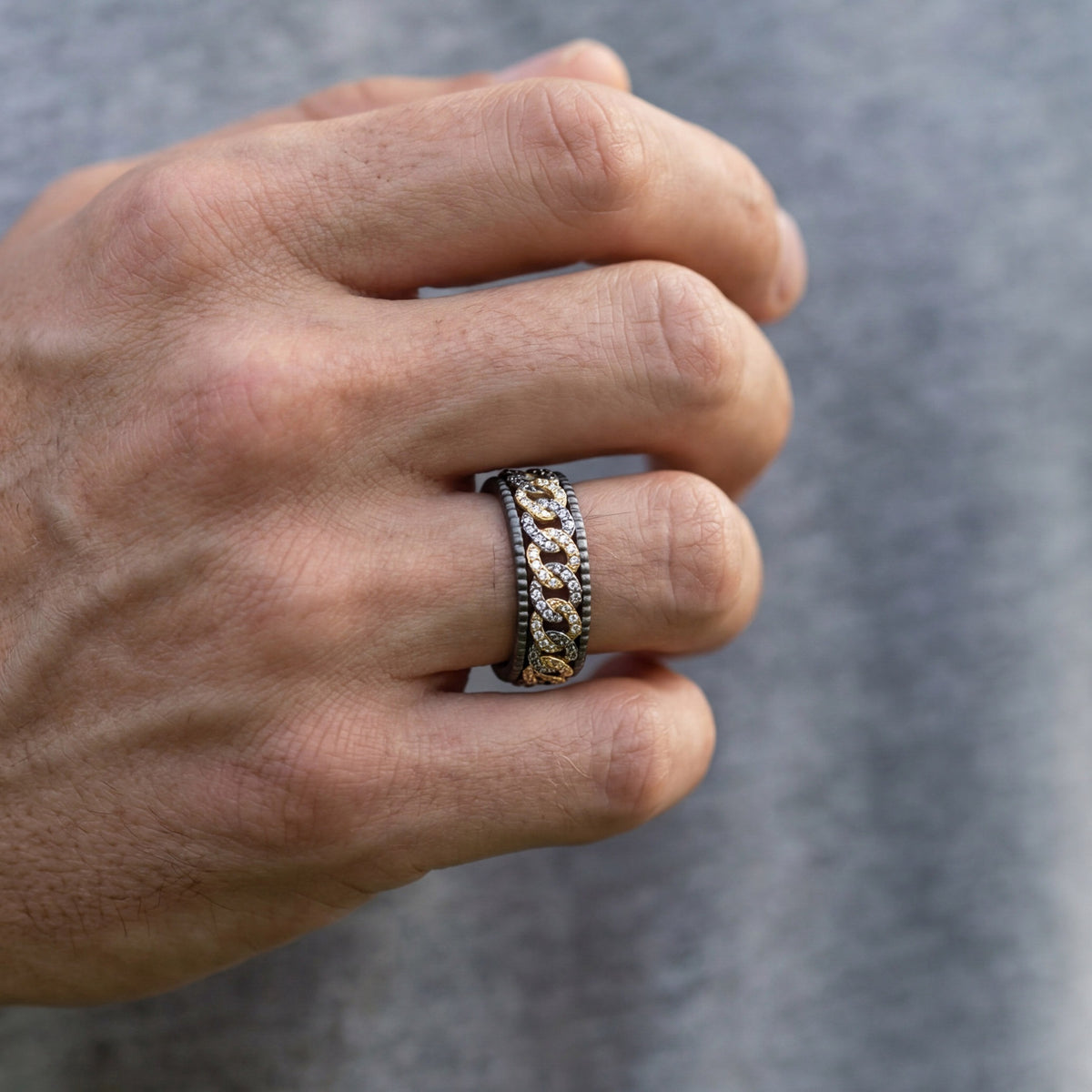 Men's titanium ring with pave moissanite chain link design in 10k gold and titanium, showcasing intricate craftsmanship and sparkle.