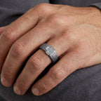 Men's titanium ring featuring a 10k yellow gold and moissanite pave cross design, showcasing detailed craftsmanship and sparkling stones