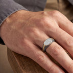Men's titanium ring with shield pave moissanite stones in 10k gold and matte finish, featuring intricate design and sparkling gemstones.