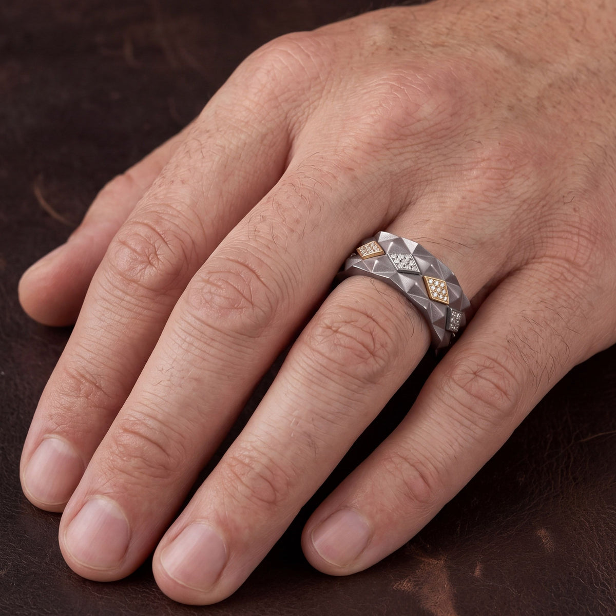 Men's titanium ring with studded 10k yellow gold and pave moissanite, showcasing a detailed, stylish jewelry design.