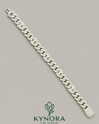 Sterling silver 10mm Moissanite diamond hip-hop bracelet by Kynora Jewels with bold, sparkling gemstone accents.