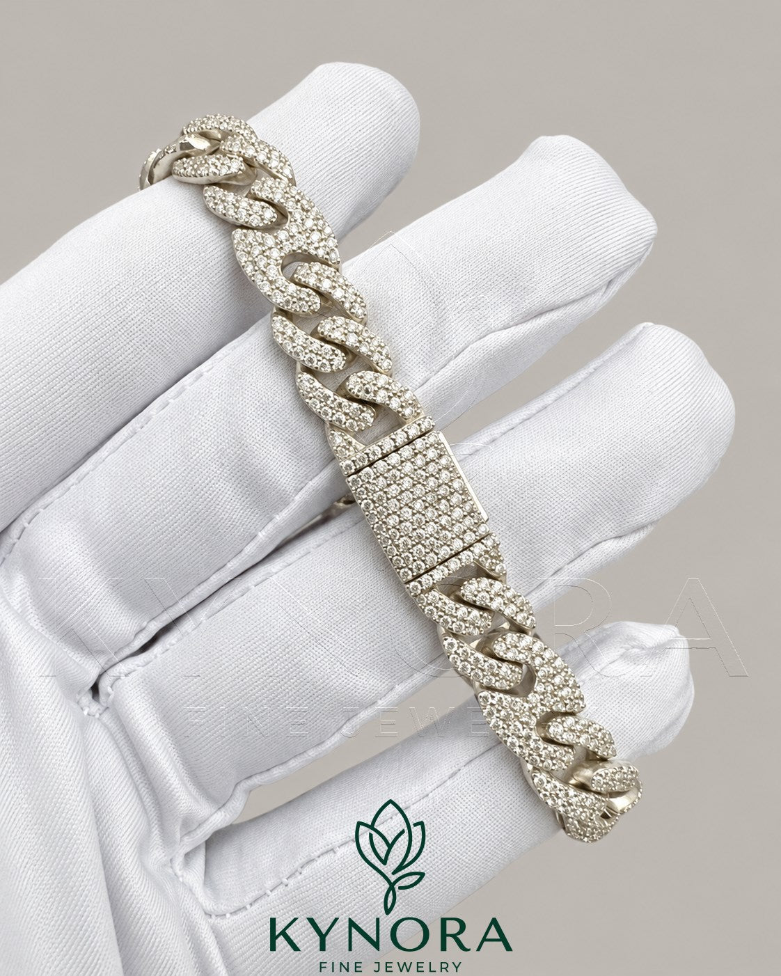 Sterling silver 10MM moissanite diamond hip-hop bracelet by Kynora Jewels with bold, sparkling gemstones and intricate chain design.
