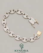 Sterling silver hip-hop bracelet with 12mm moissanite diamonds, featuring a bold design and sparkling gemstone accents.
