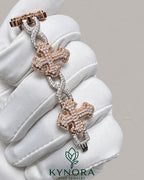 Kynora Jewels iced-out moissanite diamond cross and infinity two-tone hip-hop bracelet with sparkling gemstones and intricate design.