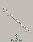 Kynora Jewels fully iced out moissanite diamond cross and infinity two-tone hip-hop bracelet featuring sparkling stones and bold design.