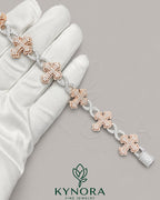 Two-tone hip-hop bracelet by Kynora Jewels featuring fully iced out moissanite diamond cross and infinity charm.
