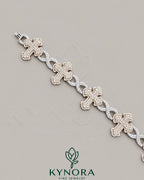 Kynora Jewels fully iced out moissanite diamond cross and infinity two-tone hip-hop bracelet, detailed close-up image.