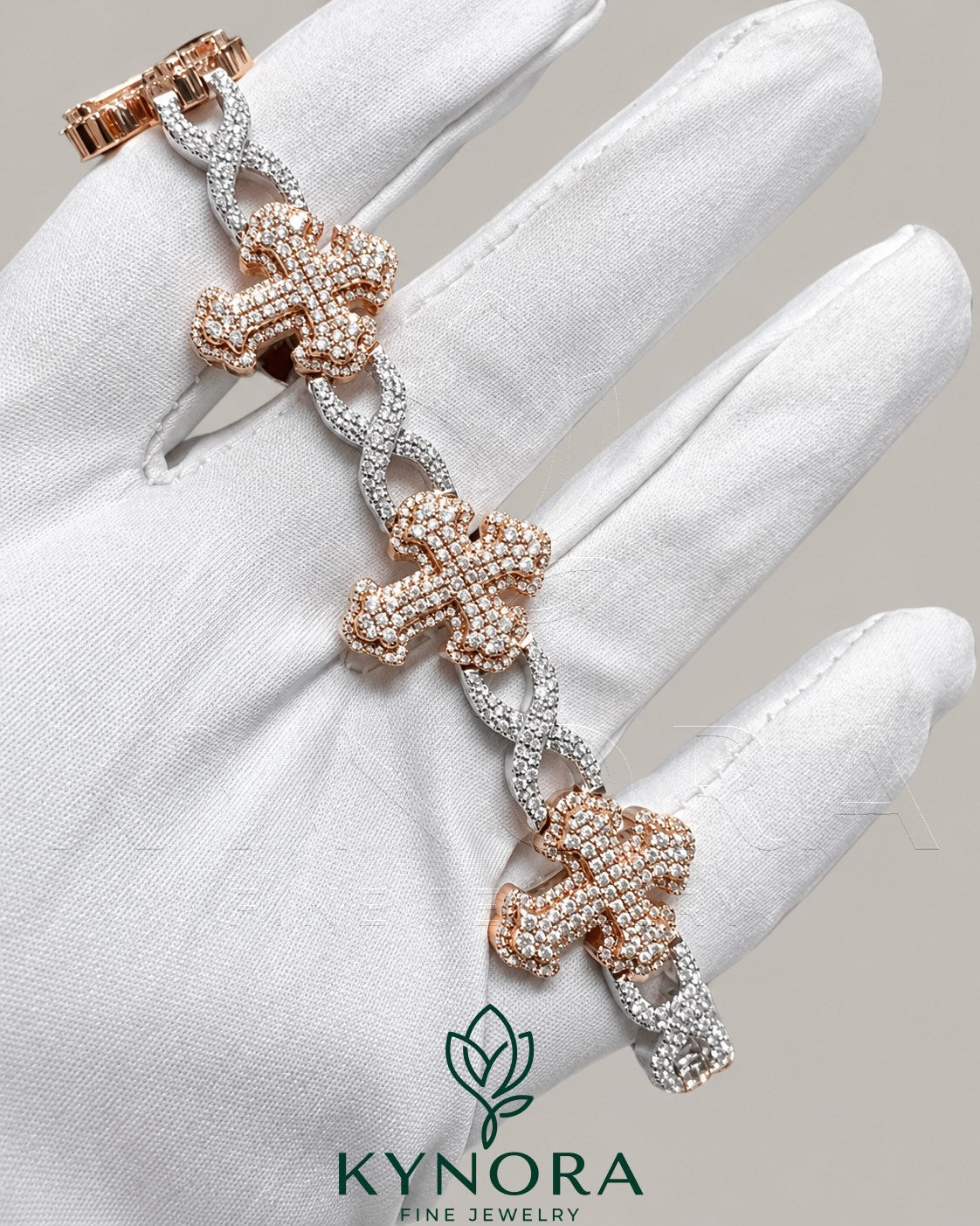 Fully iced out moissanite diamond cross and infinity two-tone hip-hop bracelet by Kynora Jewels featuring sparkling gemstones and intricate design.
